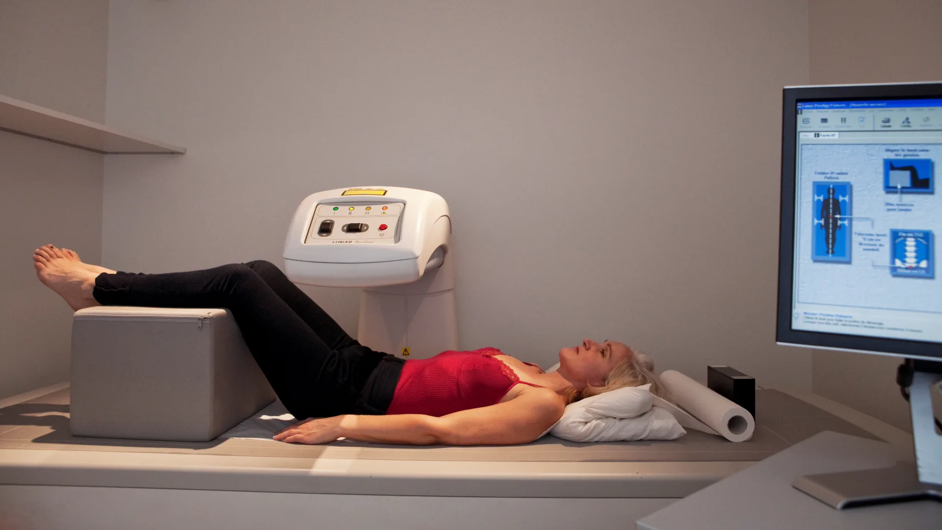Patient lying on examination table during DEXA scan